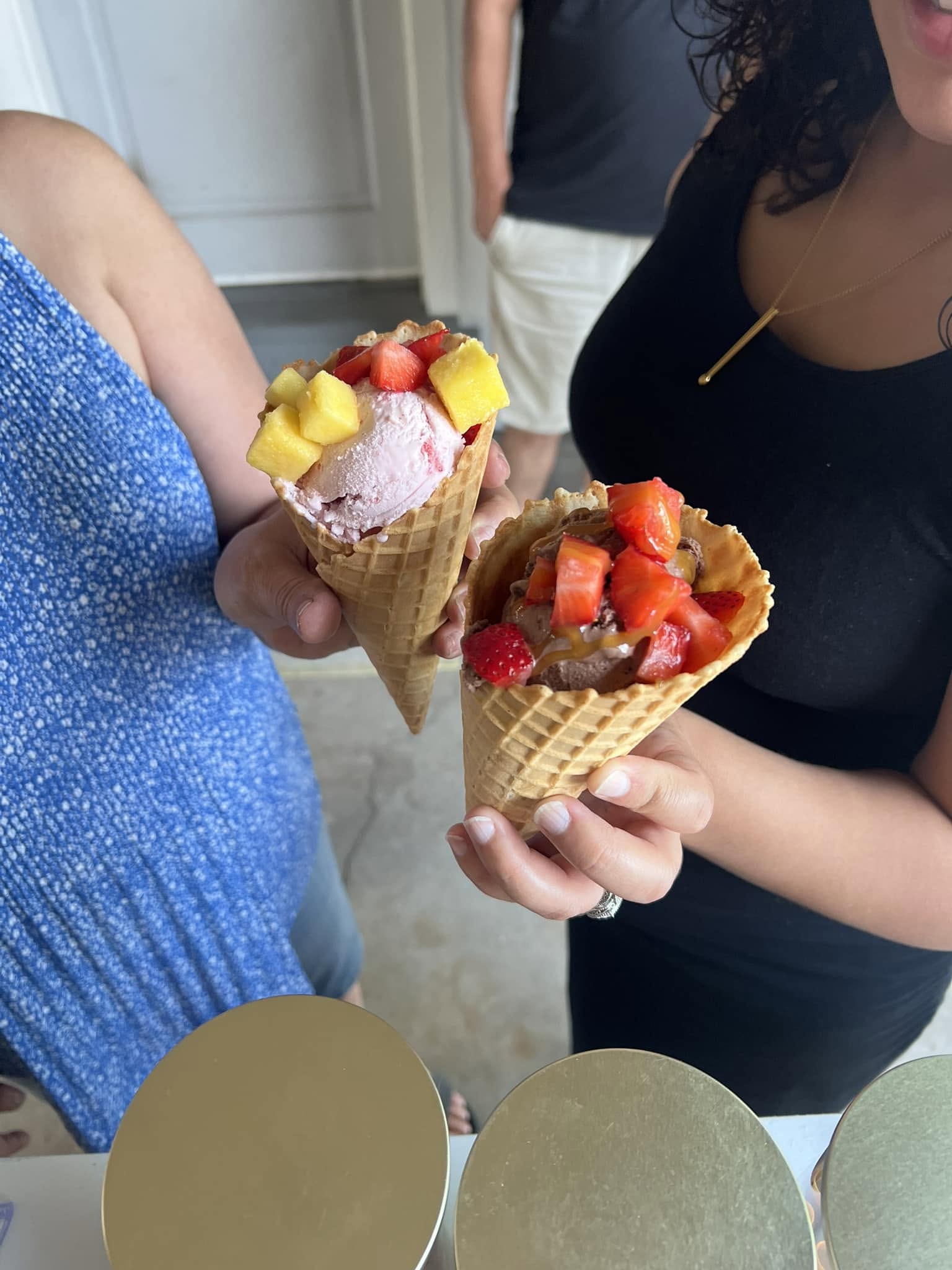 Waffle cones filled with ice cream and toppings